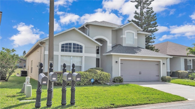 view of front property featuring a front yard, central air condition unit, and a garage