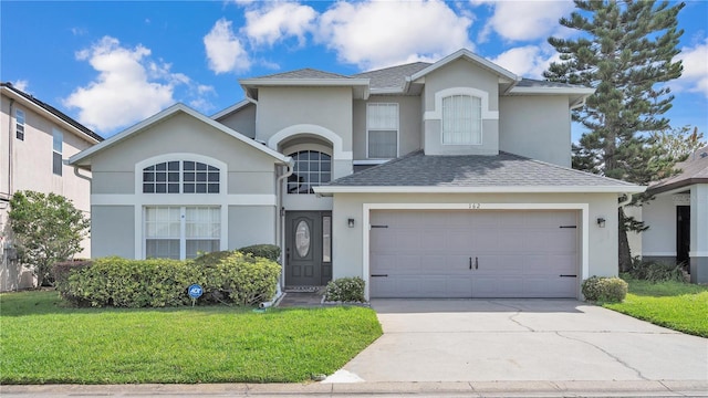 front facade featuring a front lawn and a garage