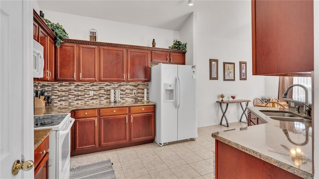 kitchen featuring white appliances, sink, backsplash, light tile flooring, and light stone countertops