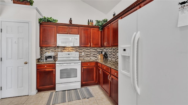 kitchen with white appliances, tasteful backsplash, vaulted ceiling, and light tile flooring