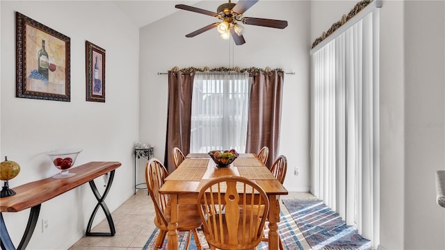 dining space featuring light tile flooring, ceiling fan, and lofted ceiling