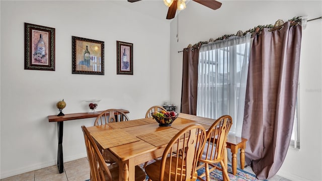 dining room with light tile flooring, a healthy amount of sunlight, and ceiling fan