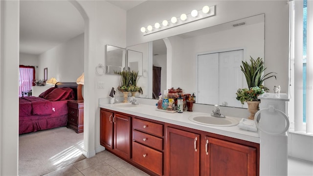 bathroom featuring double sink, tile floors, and vanity with extensive cabinet space