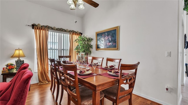 dining space featuring light hardwood / wood-style floors, ceiling fan, and vaulted ceiling