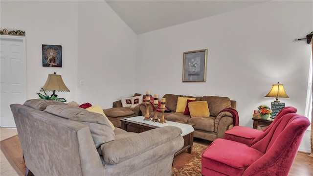 living room featuring light hardwood / wood-style floors and vaulted ceiling