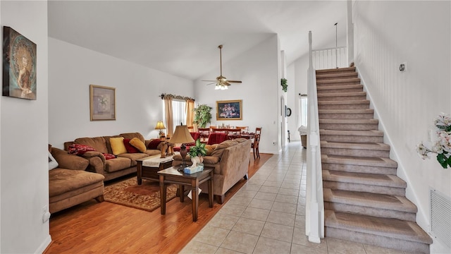 living room featuring high vaulted ceiling, ceiling fan, and light hardwood / wood-style flooring