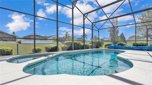 view of pool with a patio, a lanai, and a yard