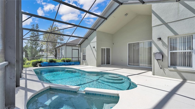 view of pool with an in ground hot tub, a lanai, and a patio area