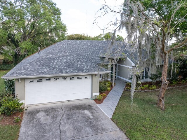 single story home with a front yard and a garage