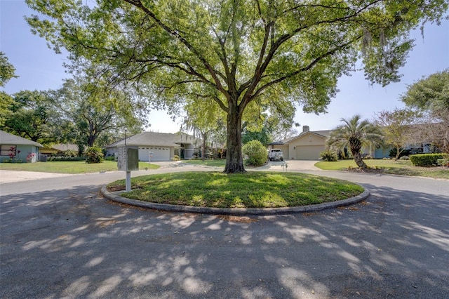 single story home with a front yard and a garage