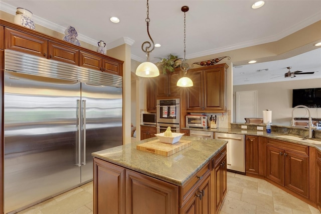 kitchen featuring pendant lighting, stainless steel appliances, a center island, ceiling fan, and light stone counters