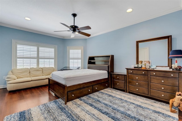 bedroom with ceiling fan, multiple windows, and dark hardwood / wood-style flooring