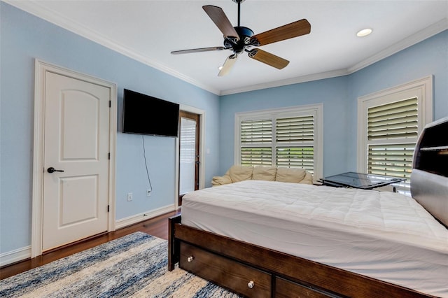 bedroom with crown molding, ceiling fan, and dark hardwood / wood-style flooring