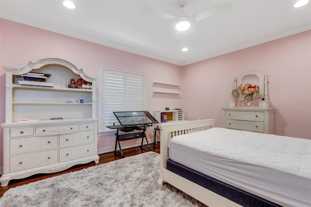 bedroom with ceiling fan, dark hardwood / wood-style flooring, and ornamental molding