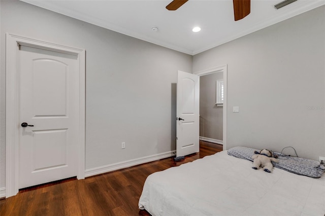 bedroom featuring ornamental molding, ceiling fan, and dark hardwood / wood-style flooring