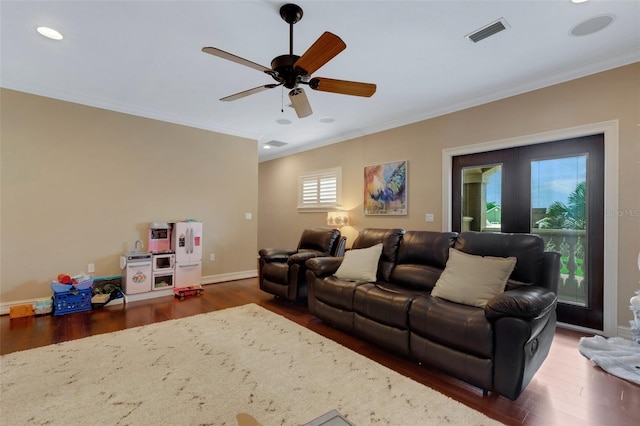 living room with crown molding, ceiling fan, french doors, and dark hardwood / wood-style flooring