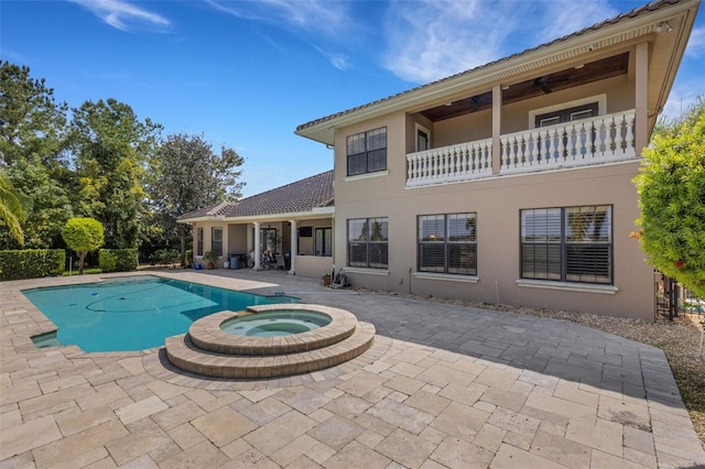 view of pool with an in ground hot tub and a patio area