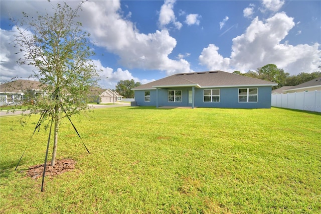 rear view of house with a yard