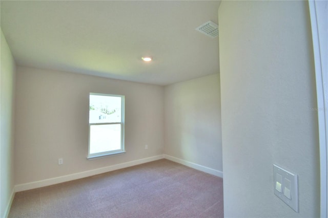 unfurnished room with light carpet