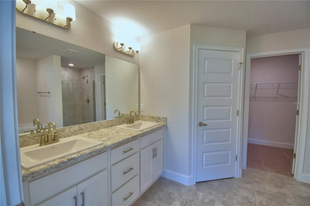 bathroom with vanity and a shower with shower door