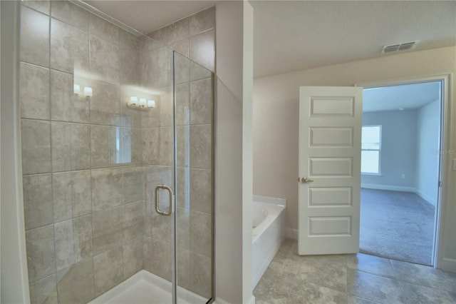 bathroom featuring independent shower and bath