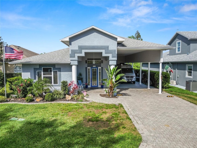 view of front of property with french doors, a carport, central AC, and a front lawn