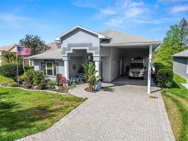 view of front facade featuring a carport and a front yard