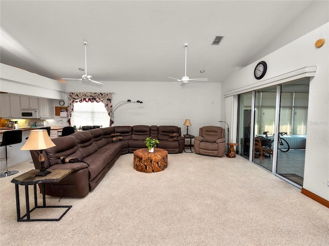 living room with vaulted ceiling, carpet floors, and ceiling fan