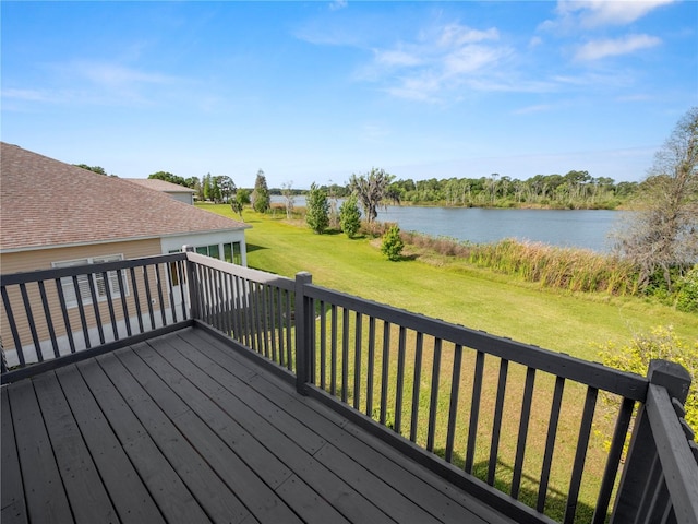 deck featuring a water view and a lawn