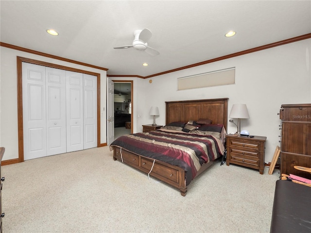 carpeted bedroom with ceiling fan, crown molding, and a closet