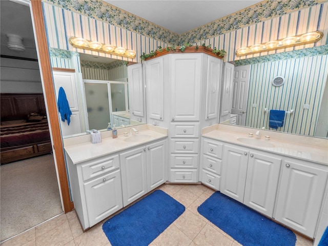 bathroom with walk in shower, tile floors, and dual bowl vanity