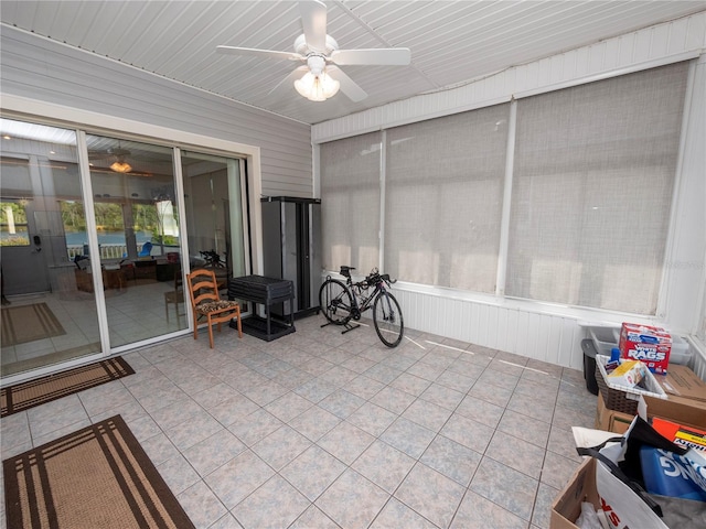 sunroom with ceiling fan and wood ceiling