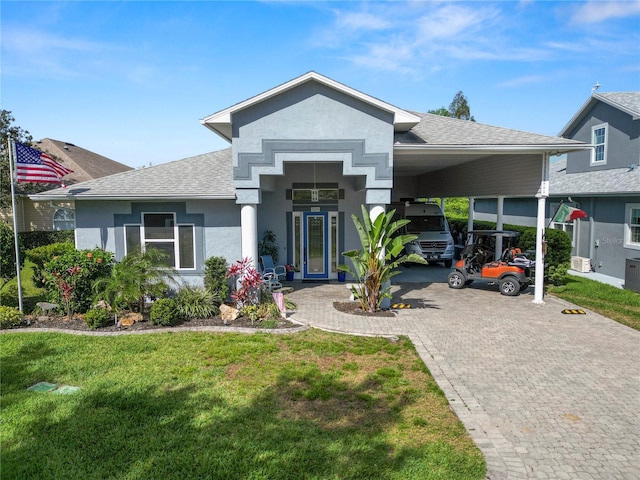 view of front of property featuring a carport, a front yard, and french doors