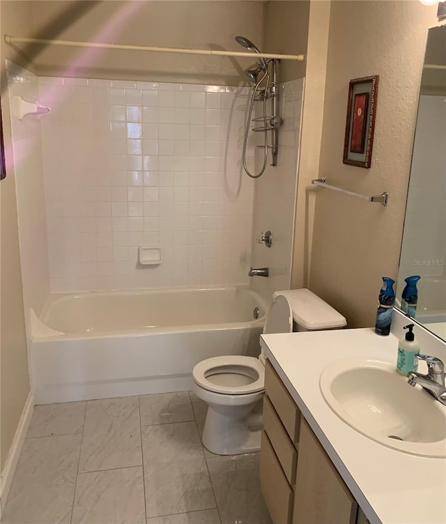 full bathroom with tiled shower / bath, toilet, vanity with extensive cabinet space, and tile flooring