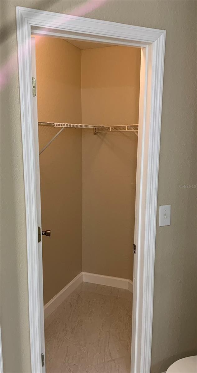 spacious closet with tile flooring