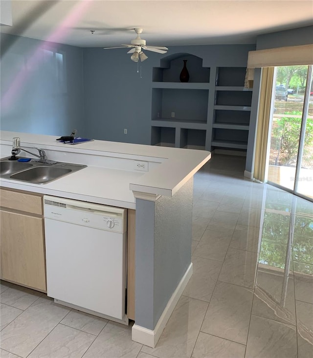 kitchen featuring white dishwasher, light tile flooring, ceiling fan, and sink