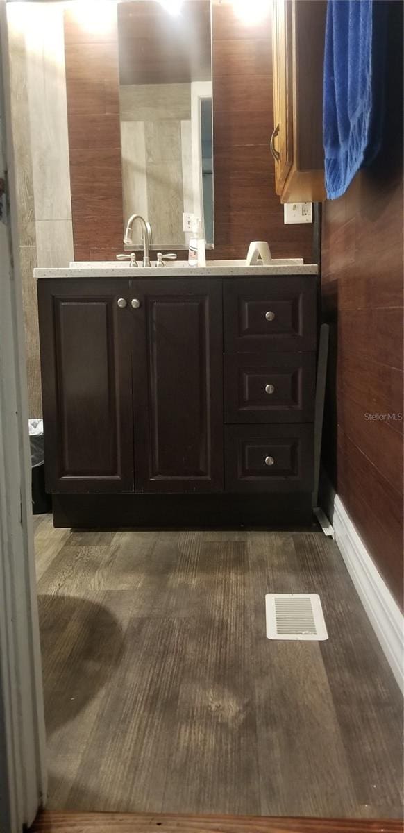 bathroom with wooden walls and vanity