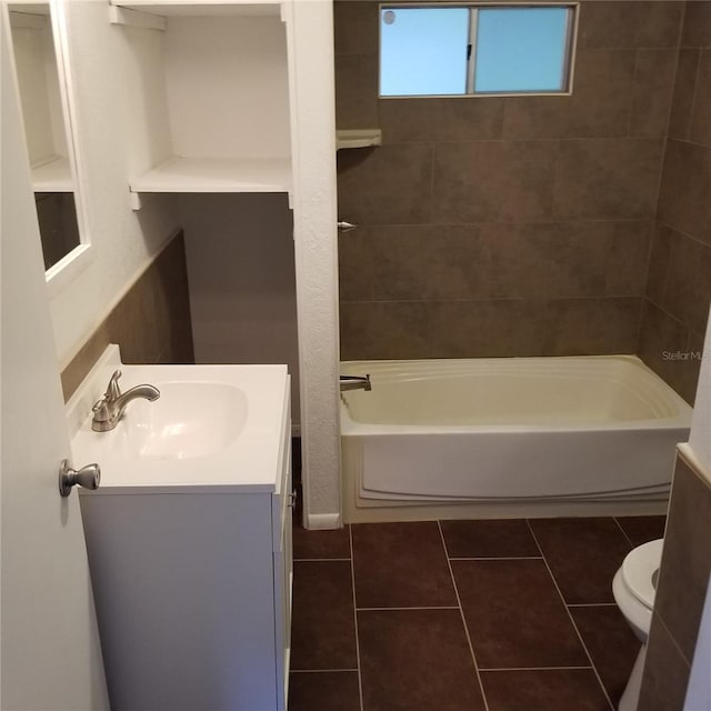 full bathroom featuring toilet, vanity, tile patterned floors, and tiled shower / bath