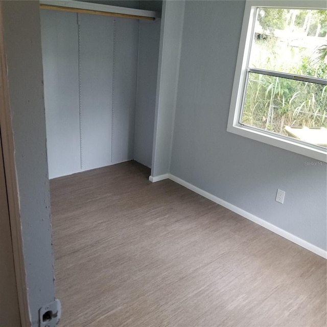 unfurnished room featuring hardwood / wood-style flooring