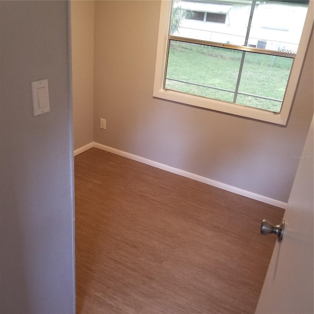 unfurnished room featuring dark hardwood / wood-style floors