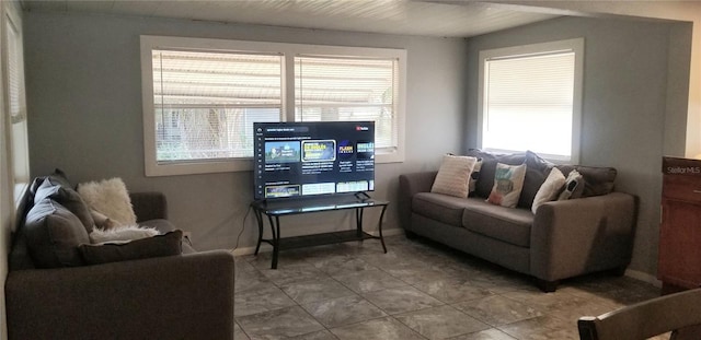 tiled living room featuring a healthy amount of sunlight