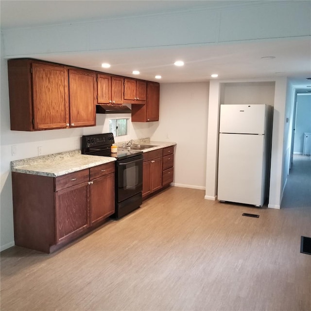 kitchen with electric range, sink, light hardwood / wood-style floors, and white refrigerator