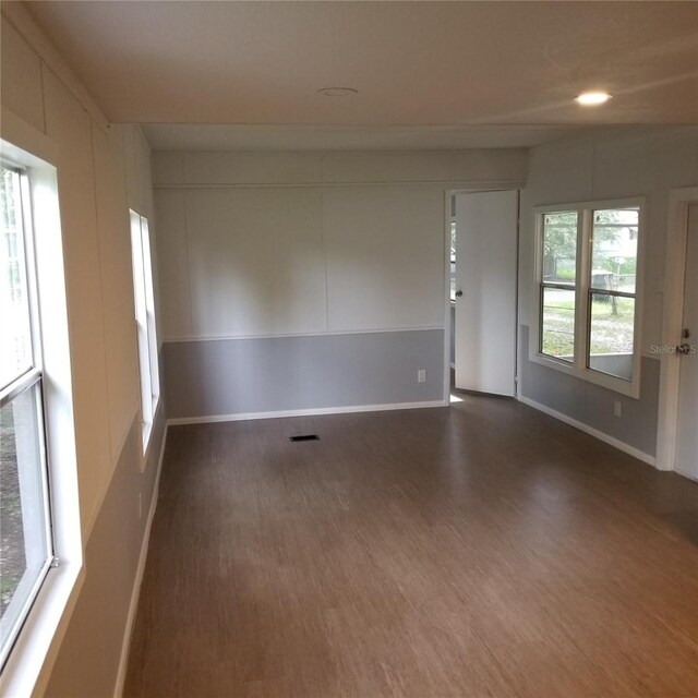 spare room featuring dark hardwood / wood-style floors