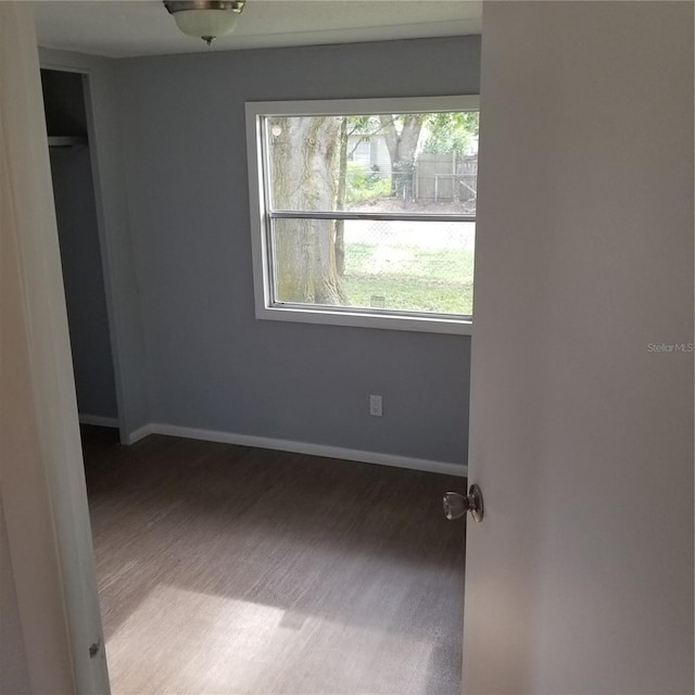 unfurnished bedroom with a closet and hardwood / wood-style flooring