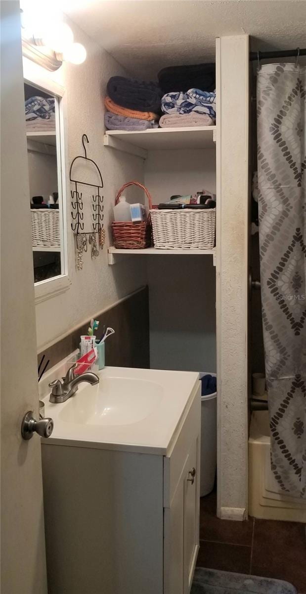 bathroom with vanity and shower / tub combo with curtain