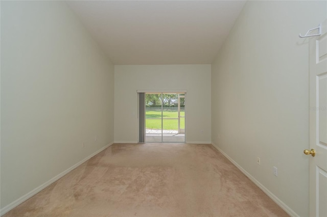 unfurnished room featuring light carpet