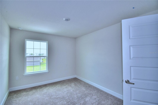 unfurnished room with light colored carpet