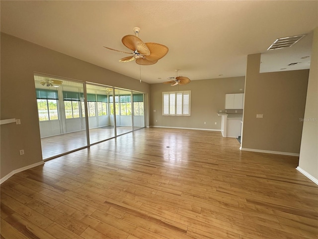 empty room with light hardwood / wood-style floors and ceiling fan