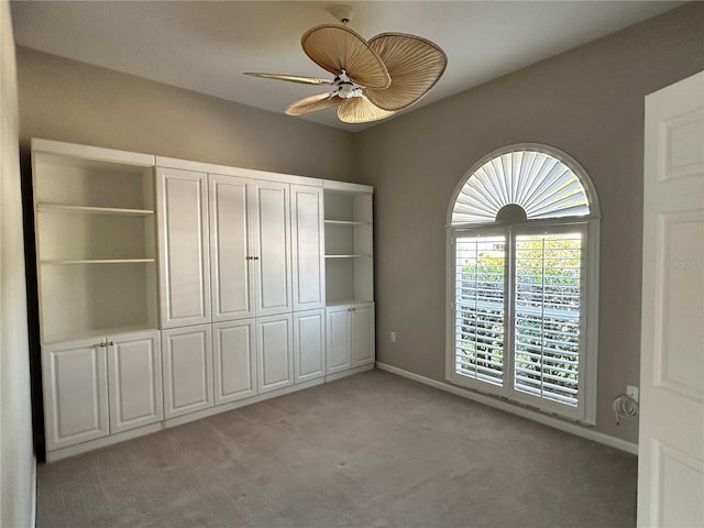 unfurnished bedroom with light colored carpet and ceiling fan