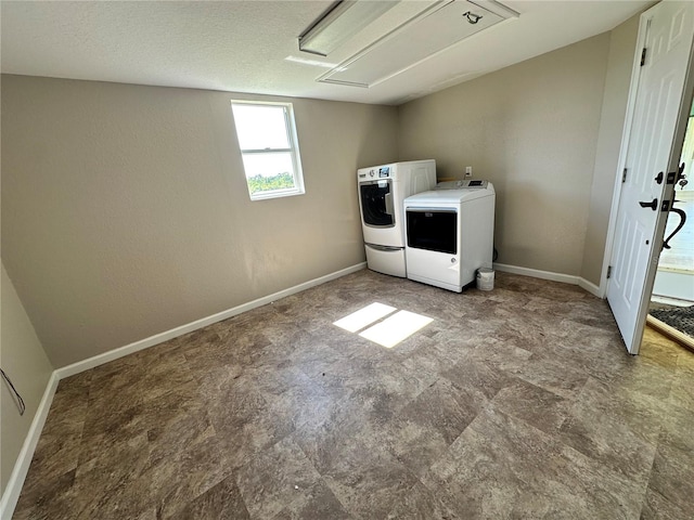 laundry area featuring washing machine and dryer and tile floors